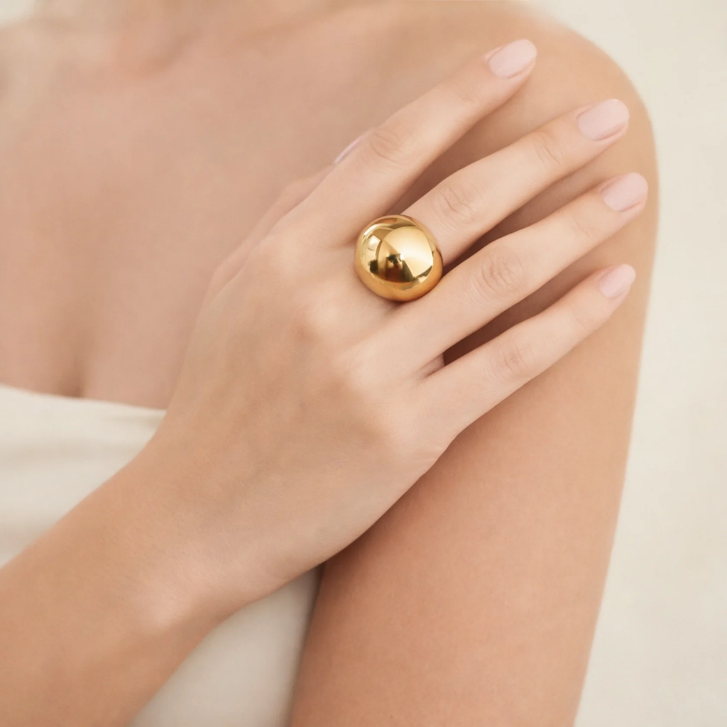 Model wearing a gold-tone dome ring