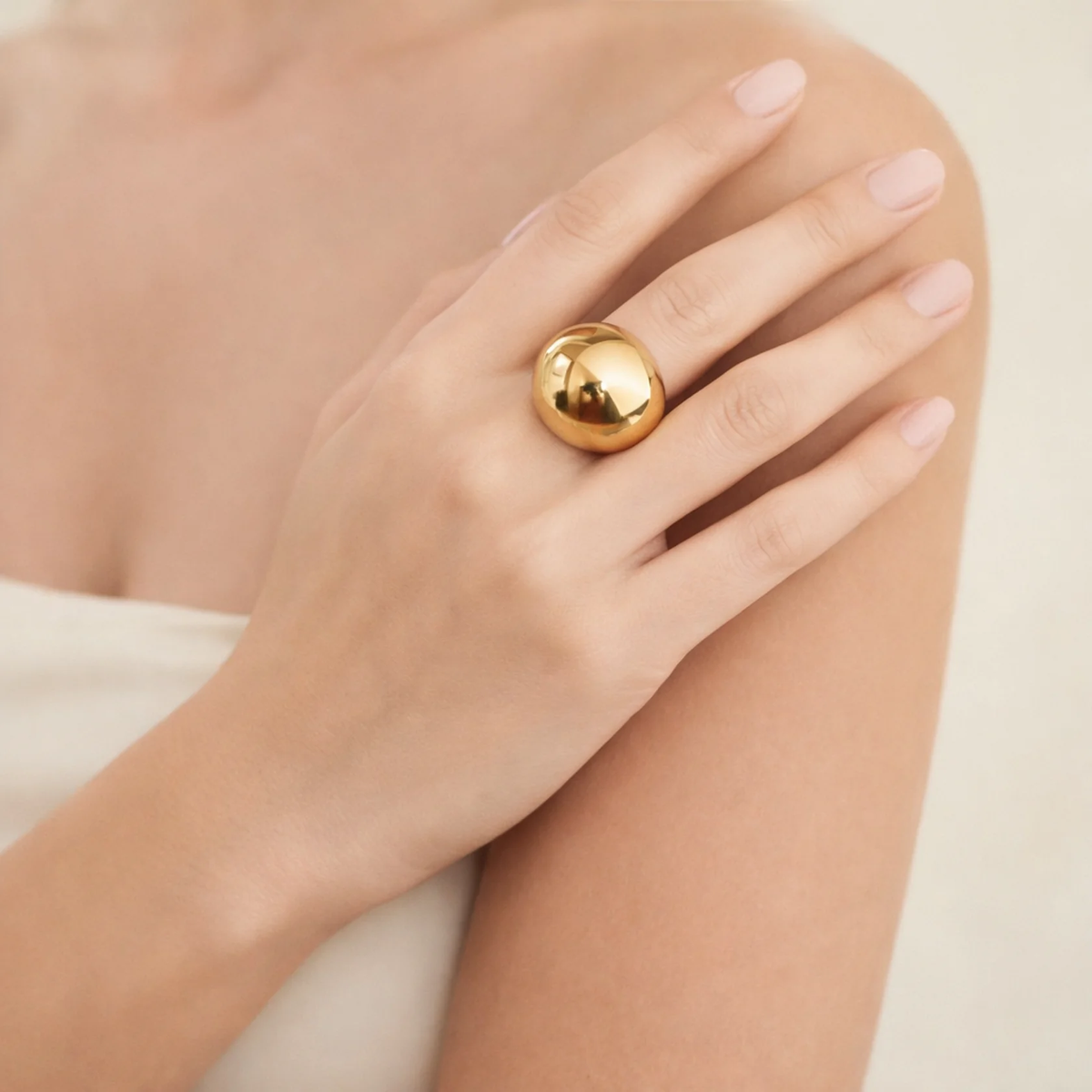 Model wearing a gold-tone dome ring
